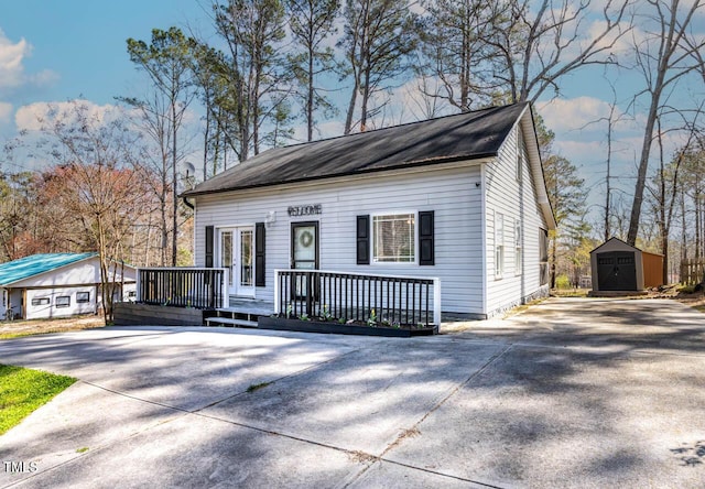 view of front of home featuring a deck and a storage shed