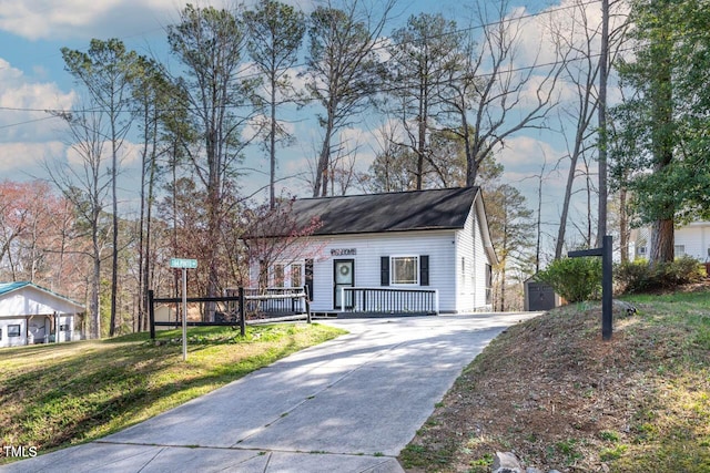 view of front of home with a front yard and covered porch