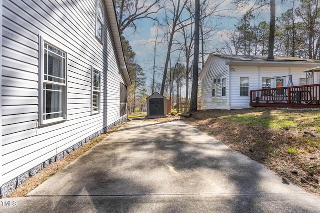 view of property exterior with a shed and a deck