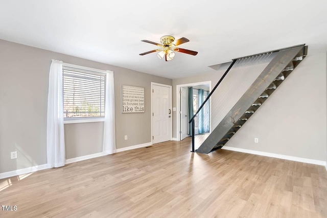 unfurnished living room with ceiling fan and light hardwood / wood-style flooring