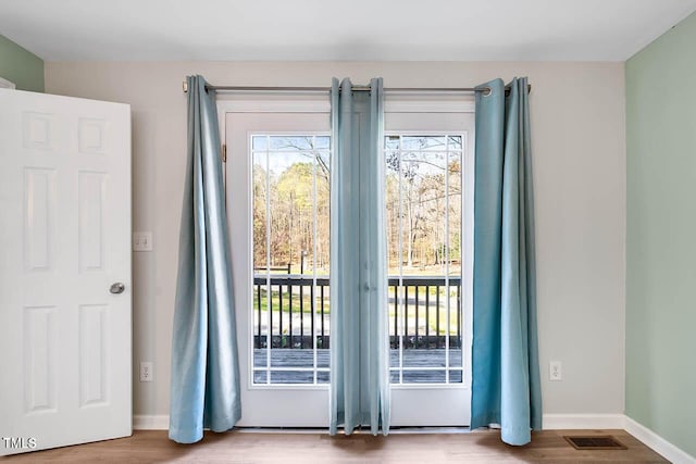 doorway featuring hardwood / wood-style floors and plenty of natural light