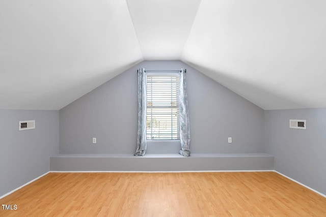 bonus room featuring light hardwood / wood-style floors and vaulted ceiling