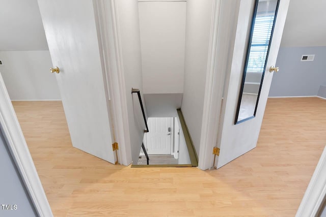 corridor with light hardwood / wood-style flooring