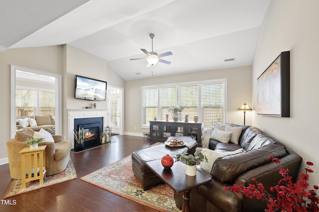 living room featuring lofted ceiling, ceiling fan, and dark hardwood / wood-style flooring