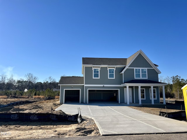 view of front of house featuring covered porch and a garage