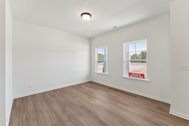 unfurnished room with light wood-type flooring