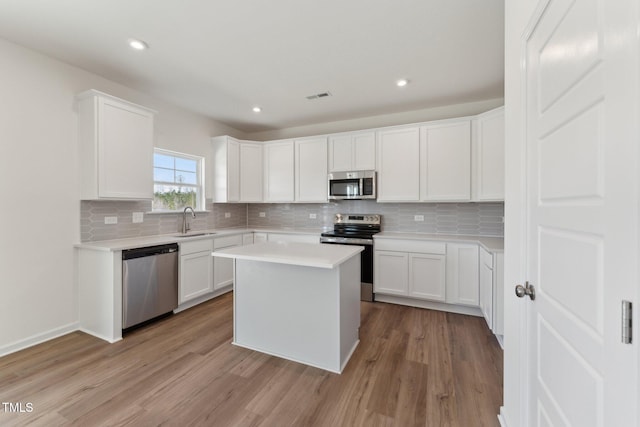 kitchen with white cabinetry, sink, and appliances with stainless steel finishes