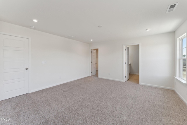 empty room with light colored carpet