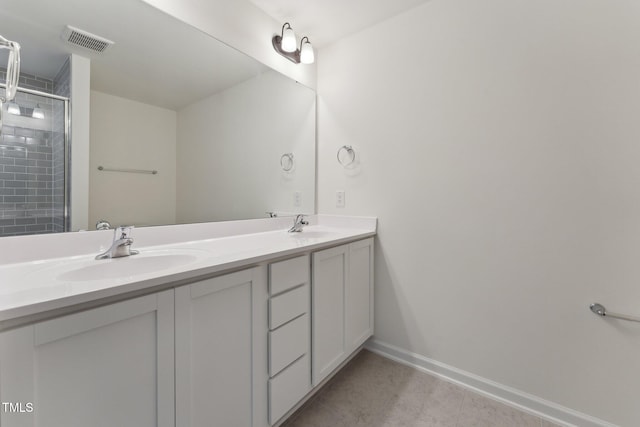 bathroom featuring vanity, tile patterned floors, and a shower with shower door