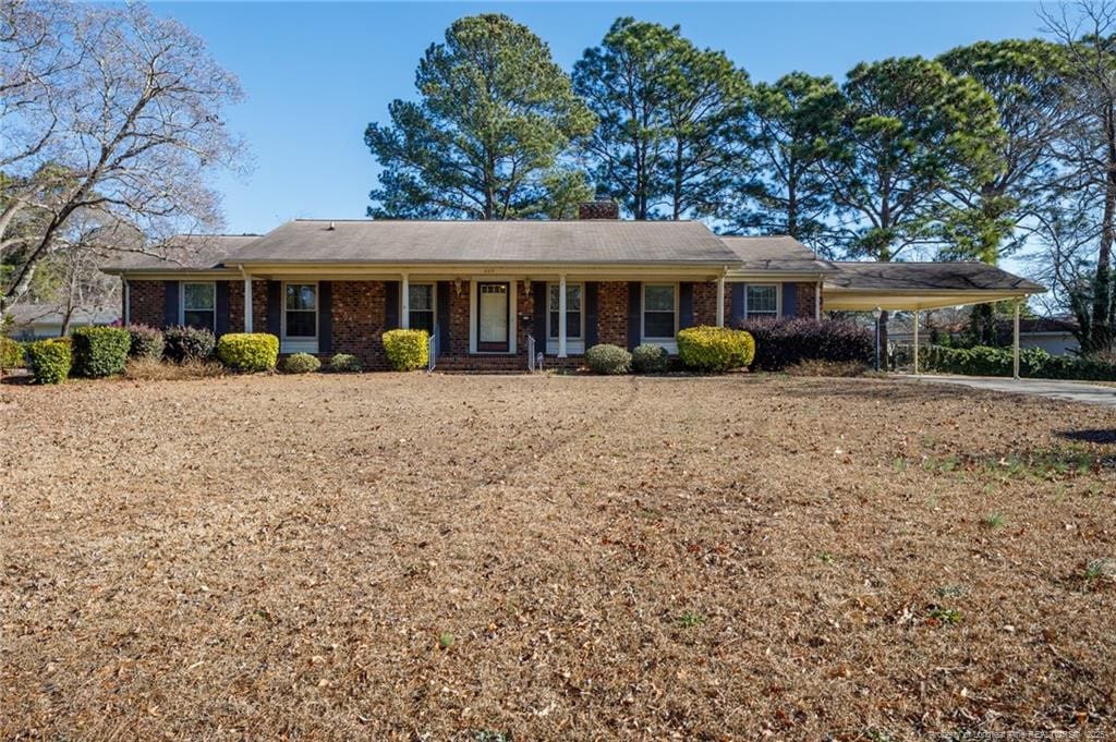 ranch-style house featuring a carport