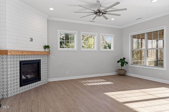 unfurnished living room with hardwood / wood-style floors, plenty of natural light, and ornamental molding