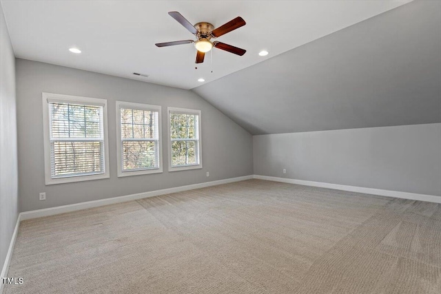 bonus room with lofted ceiling, light carpet, and ceiling fan