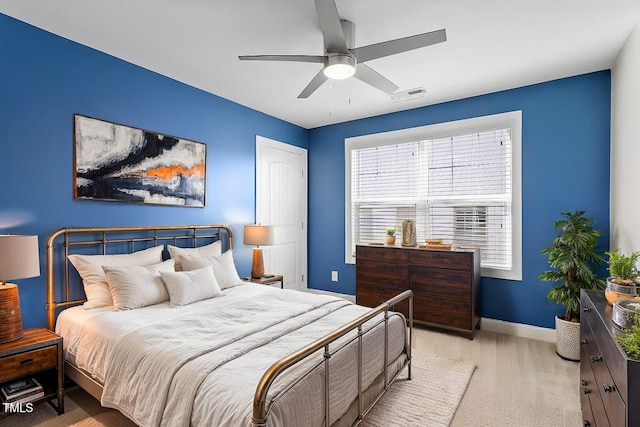 bedroom featuring light colored carpet and ceiling fan