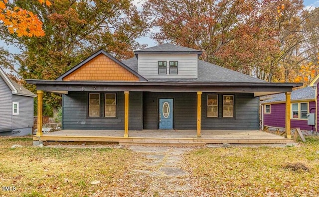 view of front of property with a front yard and covered porch