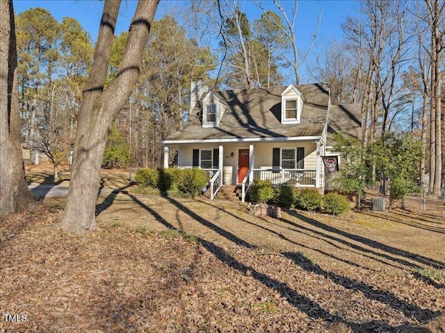 cape cod-style house featuring covered porch