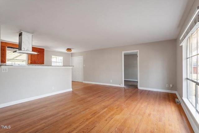 unfurnished living room with light hardwood / wood-style flooring