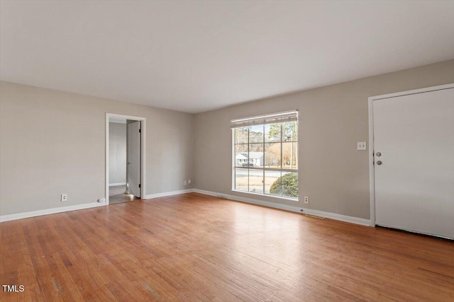 empty room with light hardwood / wood-style flooring