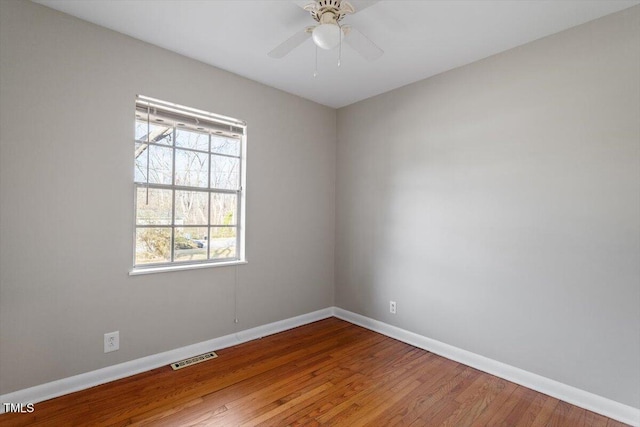 unfurnished room with hardwood / wood-style flooring and ceiling fan