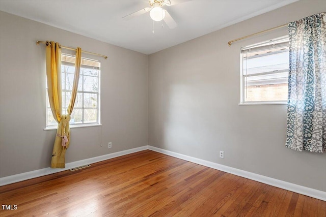 empty room with ceiling fan and wood-type flooring