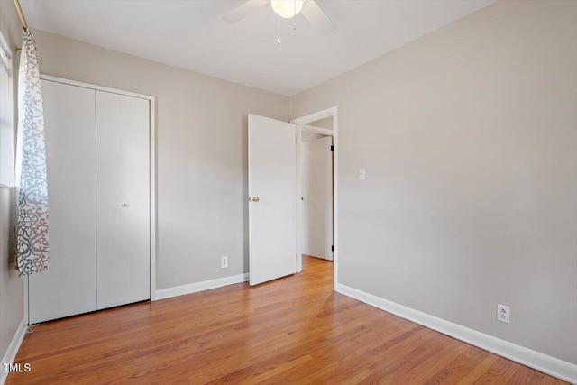 unfurnished bedroom featuring ceiling fan, a closet, and light hardwood / wood-style flooring