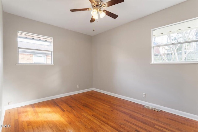 empty room featuring ceiling fan and wood-type flooring