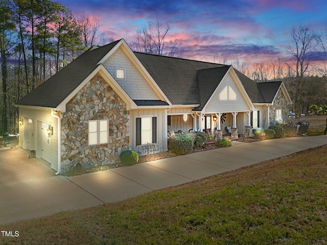 view of front of home with a lawn and a garage