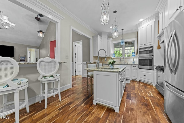 kitchen featuring white cabinets, decorative light fixtures, appliances with stainless steel finishes, and decorative backsplash