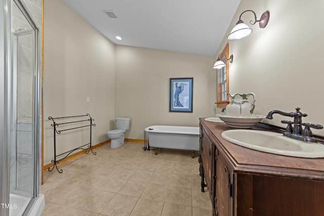 full bathroom featuring toilet, vanity, tile patterned floors, and separate shower and tub