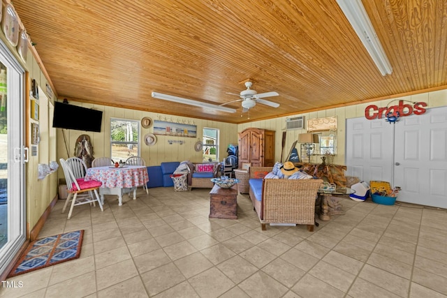 living room with ceiling fan, wooden ceiling, wood walls, and light tile patterned floors