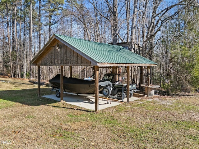 exterior space with a carport and a lawn