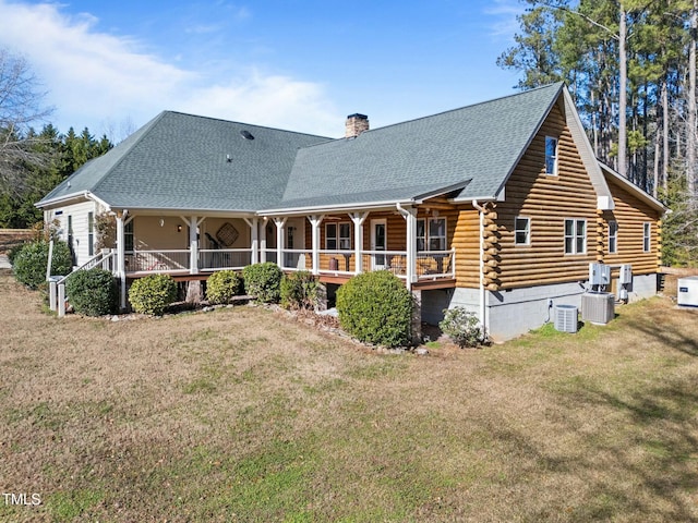 back of house with a yard, covered porch, and central AC unit