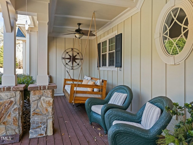 wooden terrace with covered porch and ceiling fan