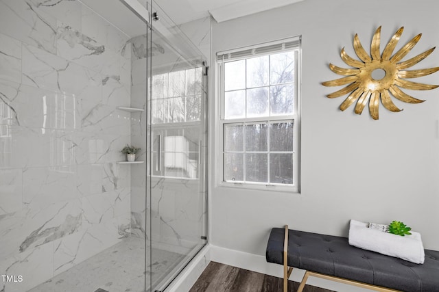 bathroom with hardwood / wood-style floors and a shower with door