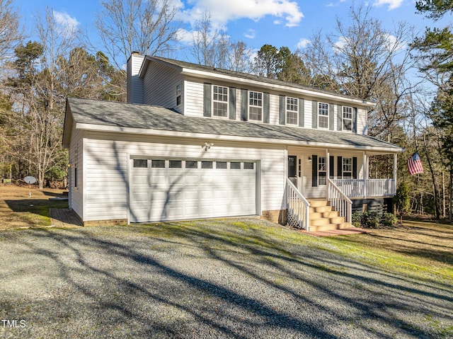 view of front of property with a garage, a front yard, and a porch