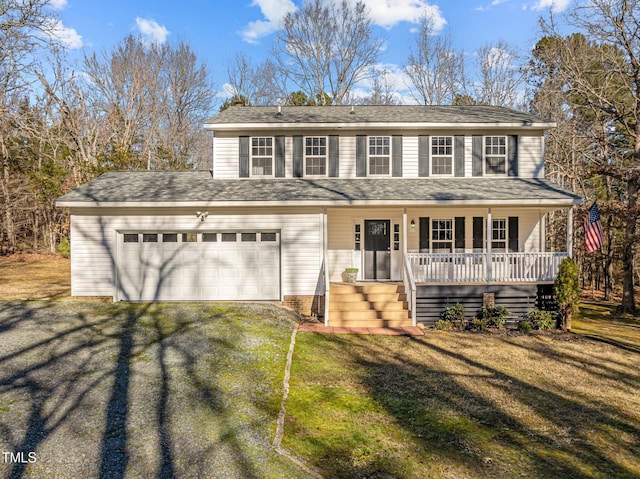 view of front of property with a front yard, a porch, and a garage