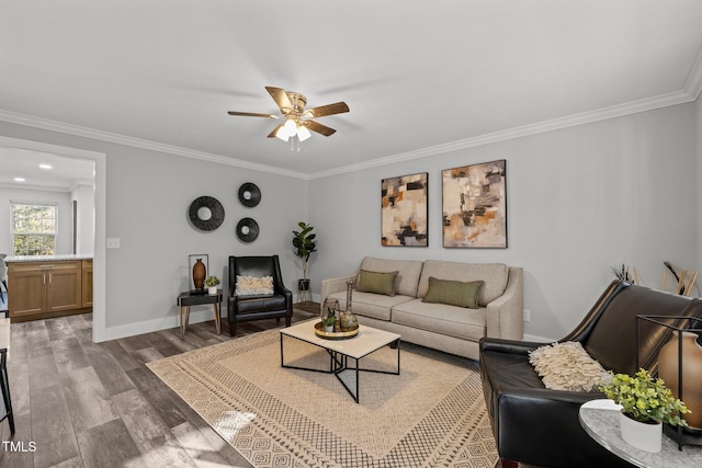 living room with hardwood / wood-style flooring, ornamental molding, and ceiling fan