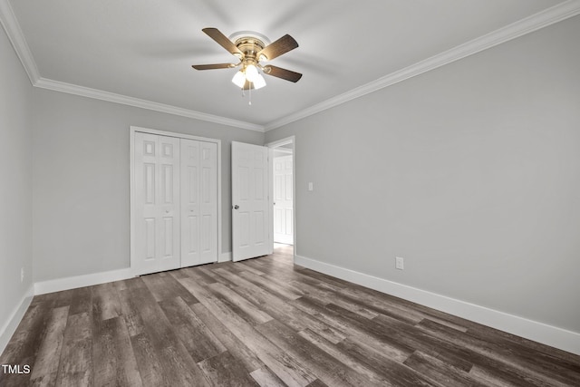 unfurnished bedroom featuring ceiling fan, ornamental molding, a closet, and dark hardwood / wood-style floors