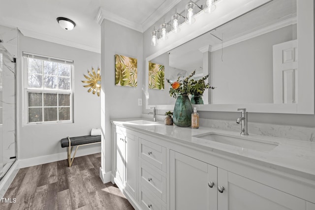 bathroom featuring hardwood / wood-style flooring, walk in shower, vanity, and ornamental molding