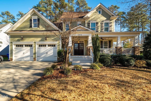 craftsman inspired home featuring a porch and a garage