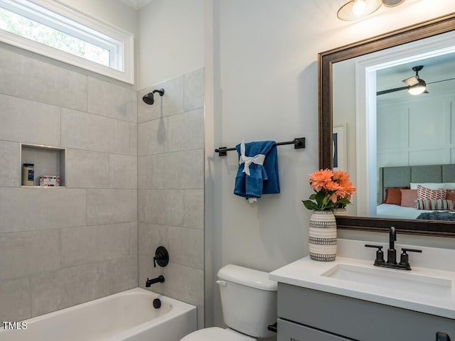 full bathroom with toilet, tiled shower / bath combo, and vanity