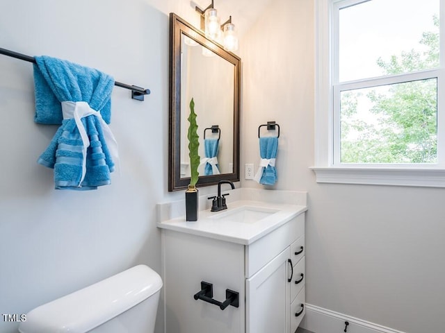 bathroom with toilet and vanity