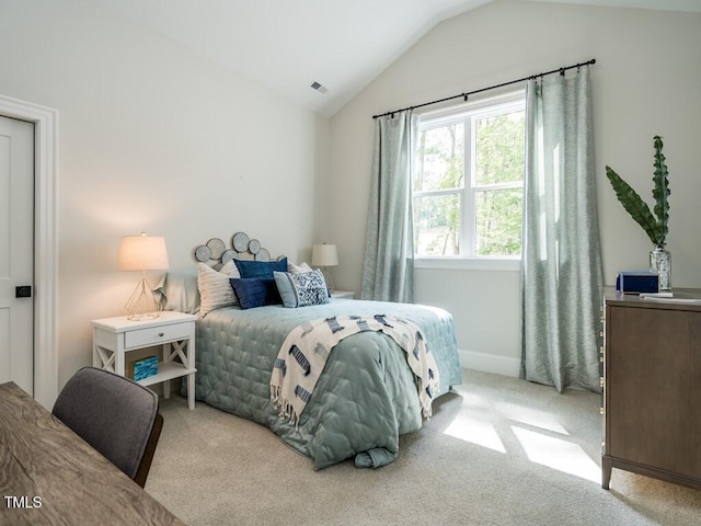 carpeted bedroom with vaulted ceiling