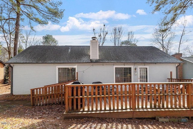 rear view of house featuring a wooden deck