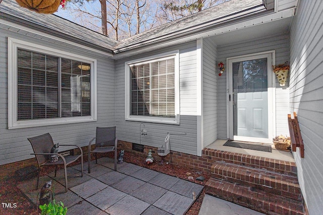 entrance to property featuring a patio area