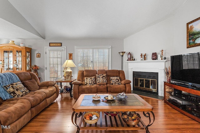 living room with hardwood / wood-style flooring and vaulted ceiling