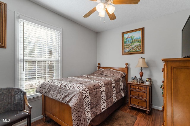 bedroom featuring ceiling fan and dark wood-type flooring