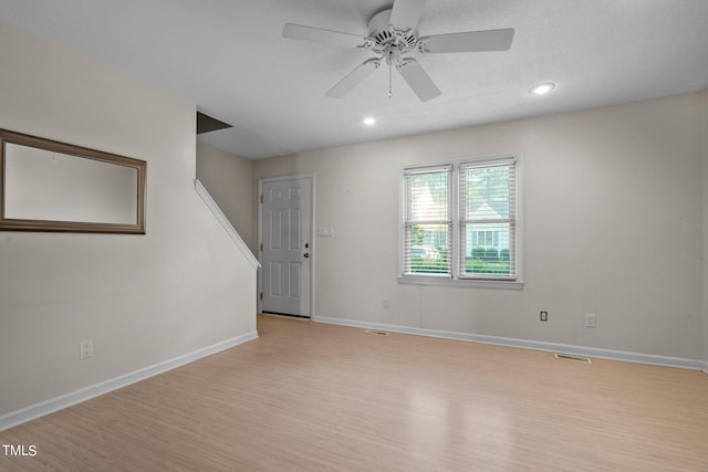 spare room with light hardwood / wood-style floors and ceiling fan