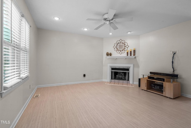 unfurnished living room with ceiling fan and light hardwood / wood-style flooring