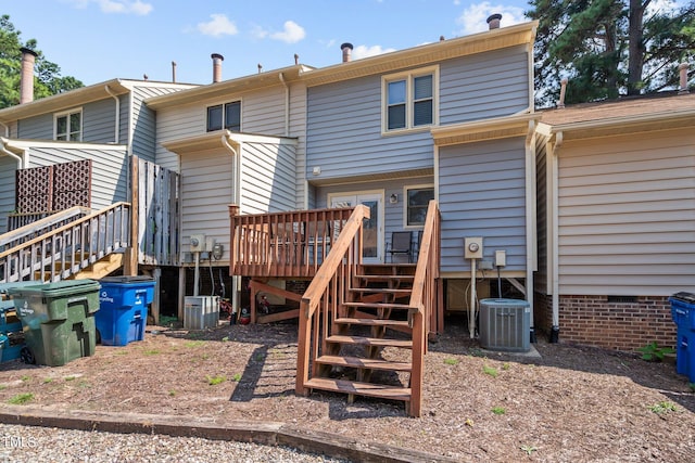 back of property featuring central AC unit and a deck