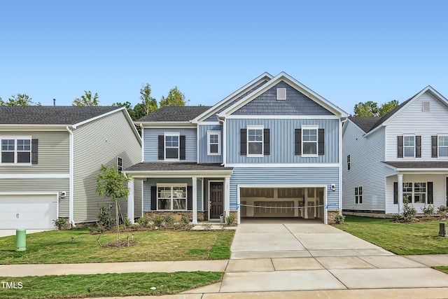 craftsman-style house featuring a front lawn and a garage